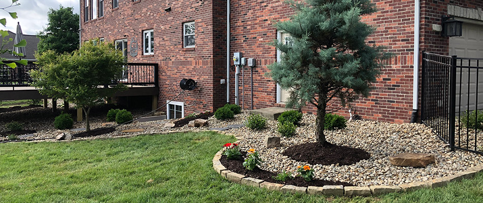 Our client's newly revamped landscape beds topped with rock in Edwardsville, IL.