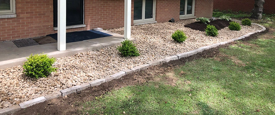 Freshly installed landscape bed topped with rock and edged with natural stone at our client's home in Glen Carbon, IL.
