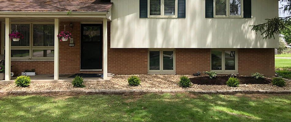 Newly installed landscape bed topped with rock in front of our client's home in Glen Carbon, IL.