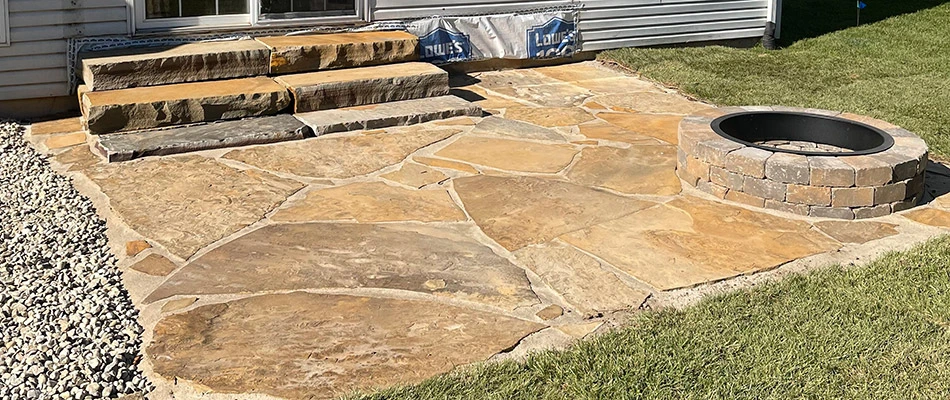 Newly installed stone steps and fire pit in our client's backyard in Edwardsville, IL.