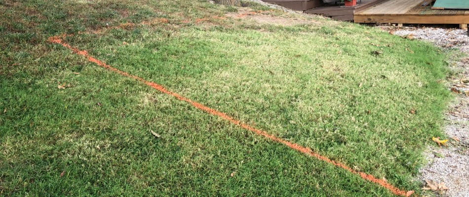 An orange spray paint outline on our client's lawn before beginning construction in Glen Carbon, IL.