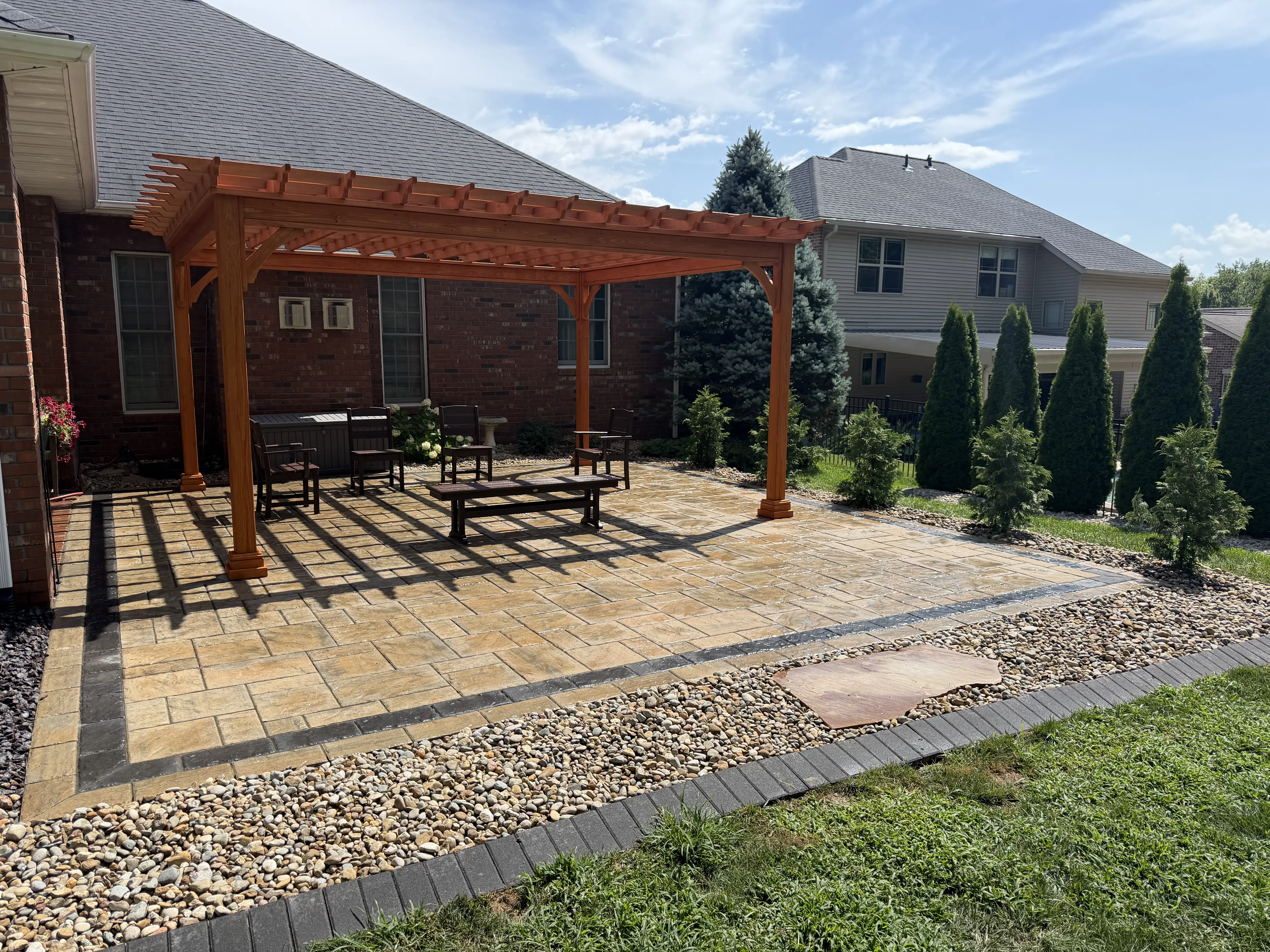 Outdoor living space with a custom fire pit and seating area in Edwardsville, IL.