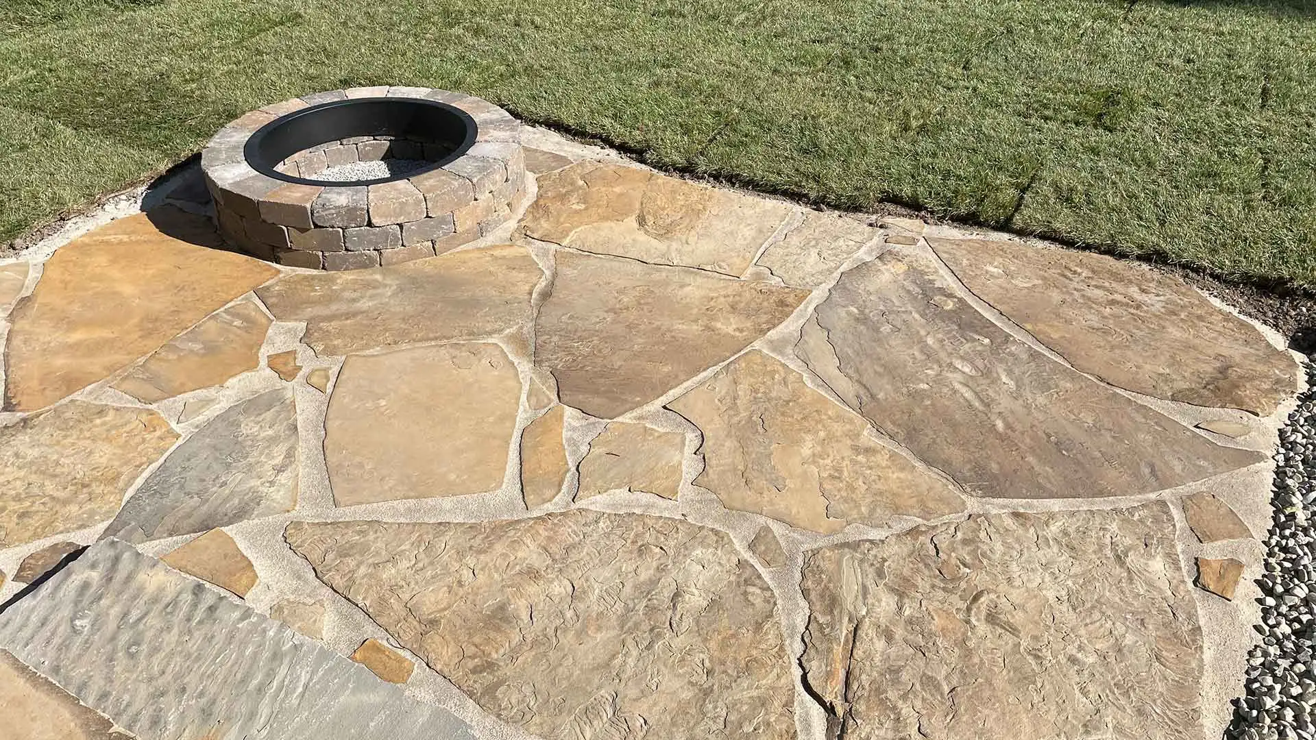 Flagstone paver patio installed with a firepit in Staunton, IL.