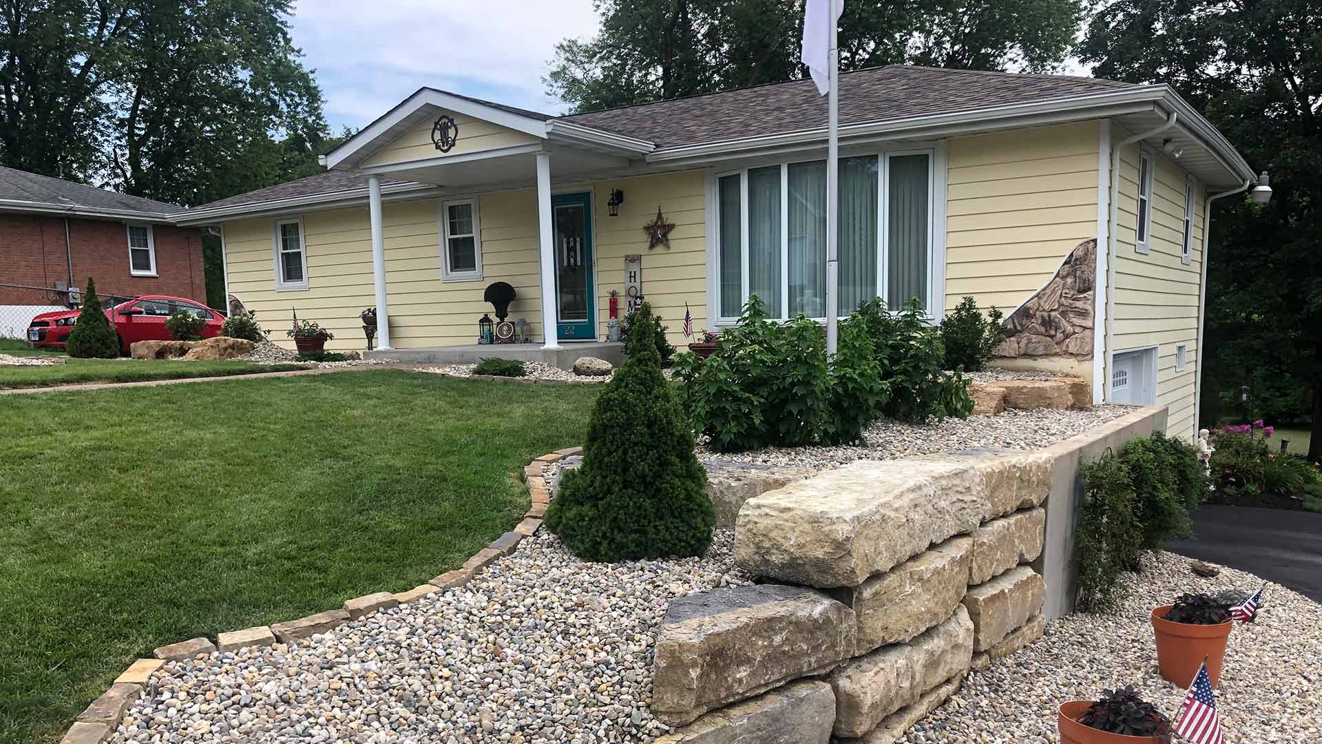 Retaining wall and landscape beds with rock ground covers in Moro, IL.