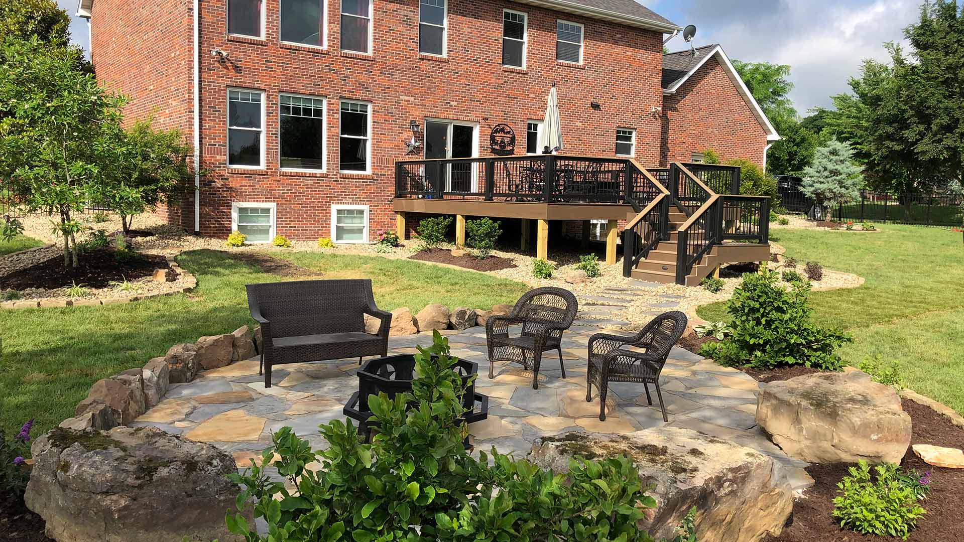 A backyard in Grafton, IL consisting of a recently constructed patio and walkway.