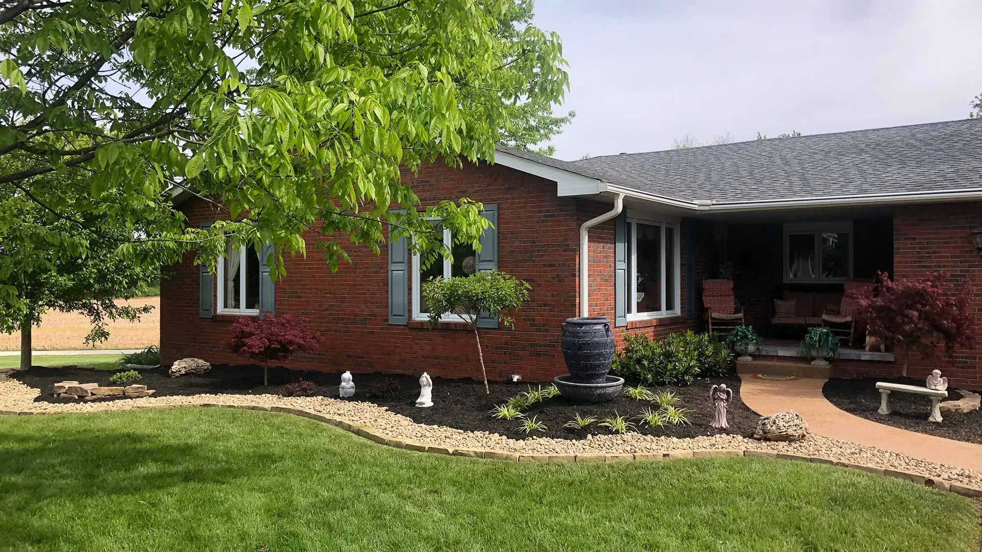 A home front in Godfrey, IL with well maintained lawn and landscape. 