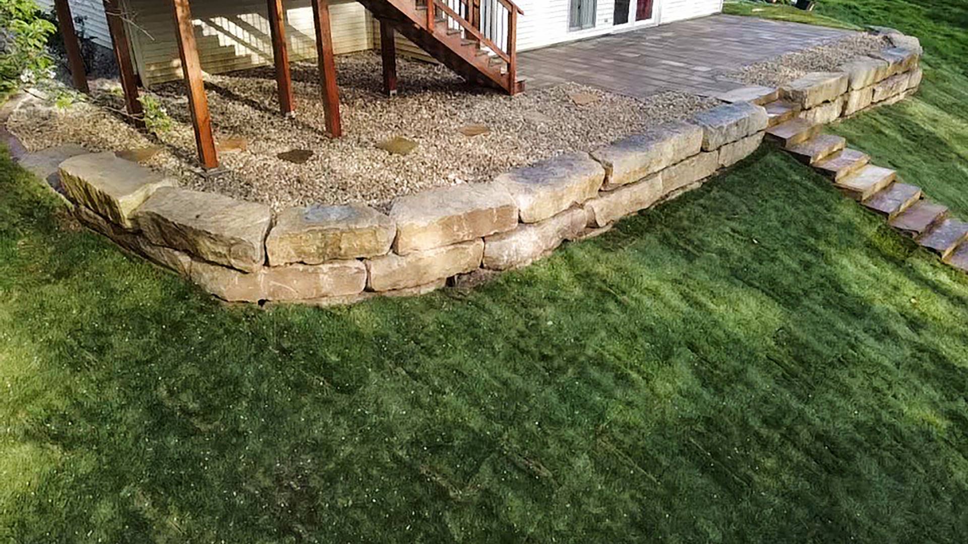 A newly build retaining wall and walkway built in a backyard in Highland, IL.