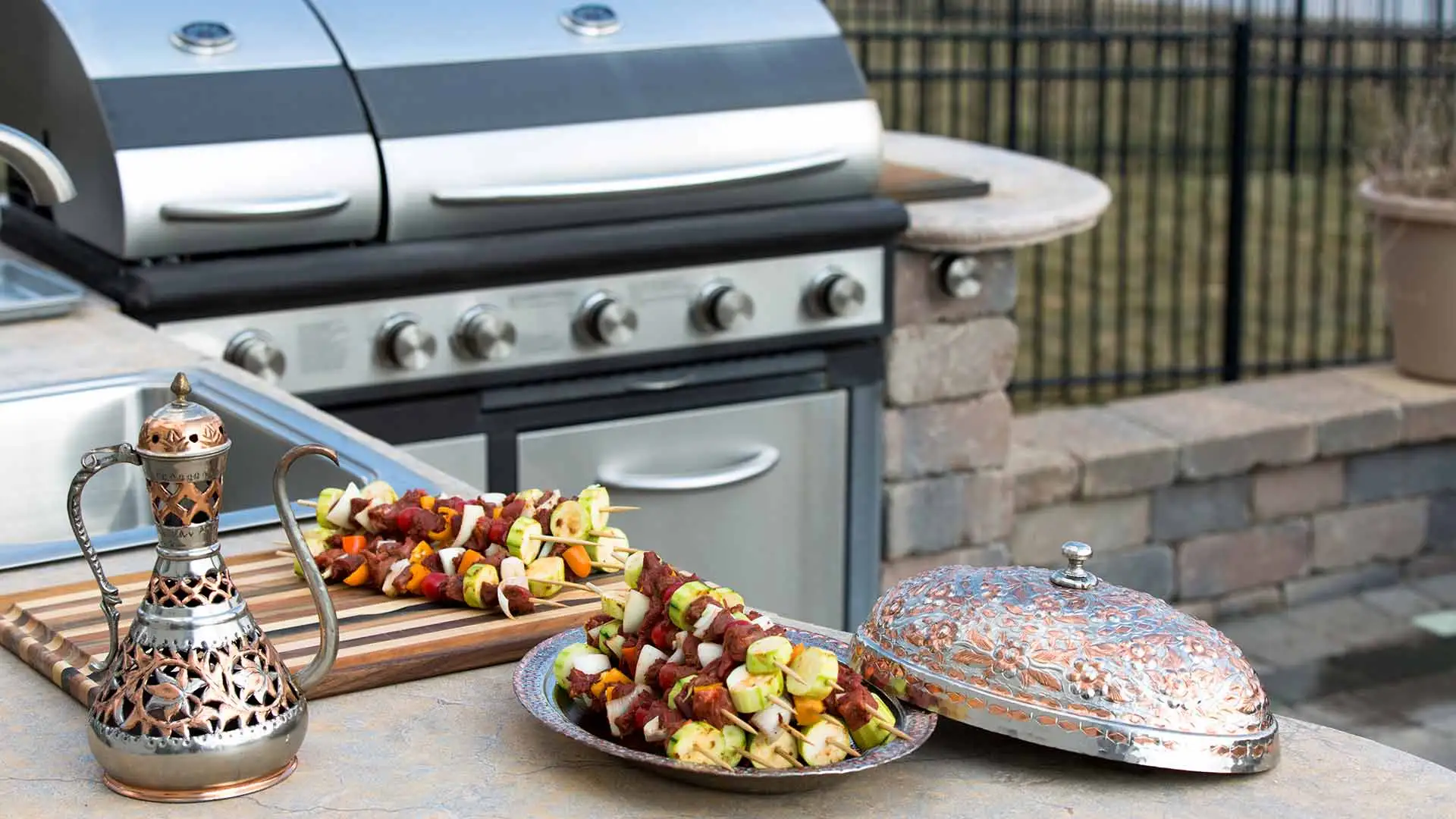 Outdoor kitchen with a grill and sink in Bethalto, Illinois.