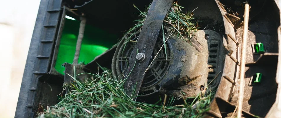 Mower in Edwardsville, IL, clogged with wet grass.