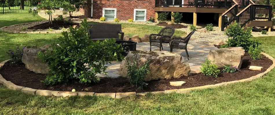Mulched landscape in Edwardsville, IL, around a patio.