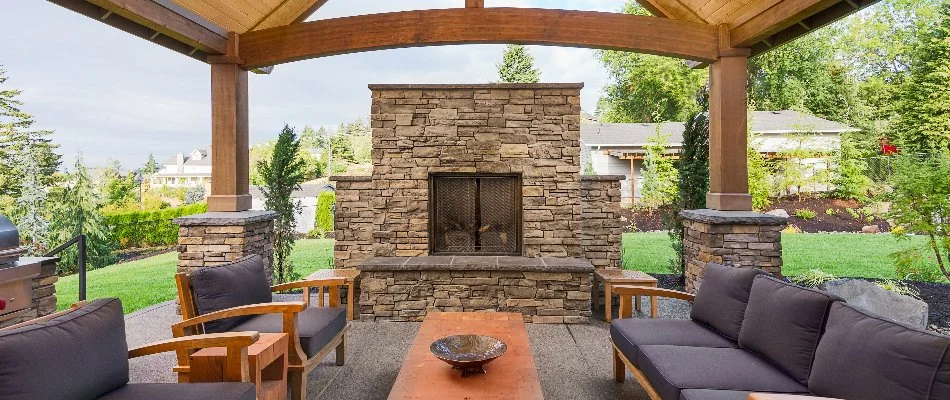 Outdoor fireplace with furniture seating in Edwardsville, IL.