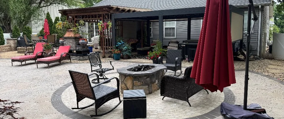 Patio, fire pit, pergola, and a red umbrella in Edwardsville, IL.
