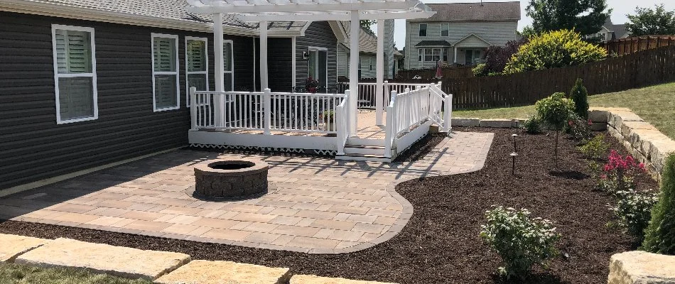 Paver patio with a fire pit and landscape bed in Edwardsville, IL.