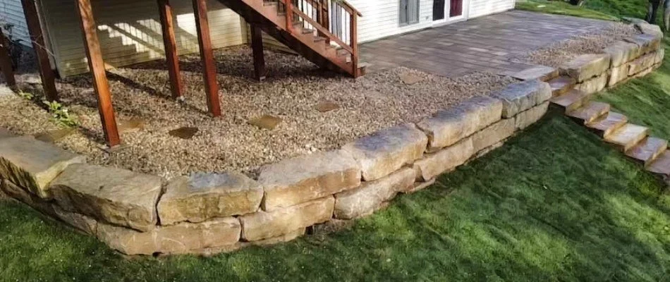 Retaining wall in Edwardsville, IL, with patio and outdoor steps.