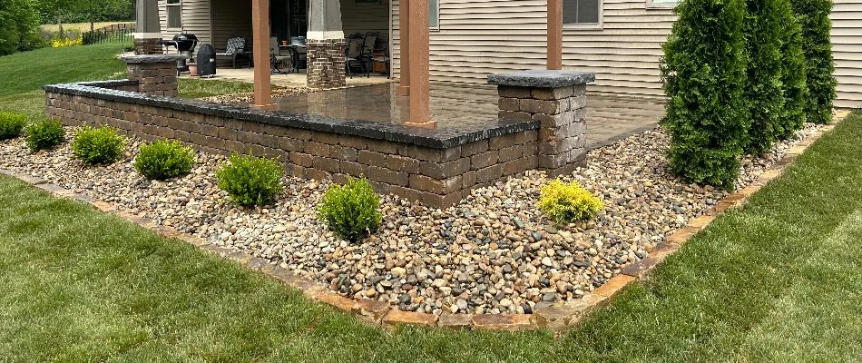 Rocks and plants in a landscape around a patio in Edwardsville, IL.
