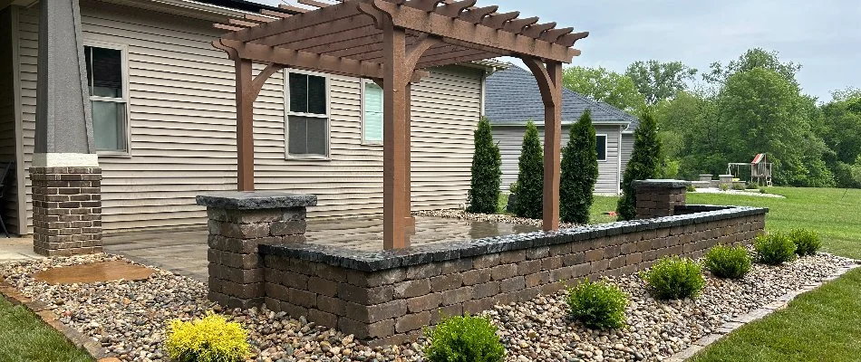 Seating wall on a patio in Edwardsville, IL, with pergola.