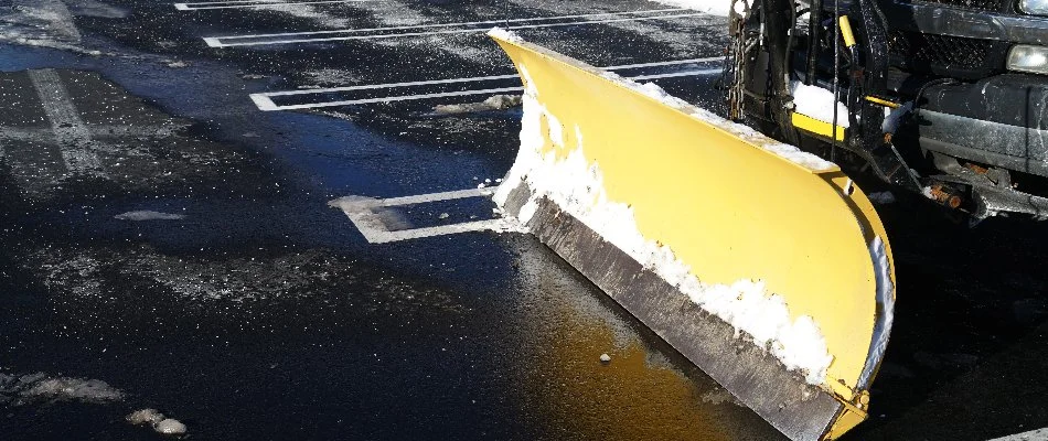 Snow plow on cleared parking lot in Edwardsville, IL.