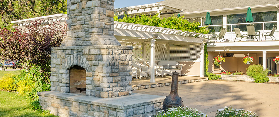 Custom stone outdoor fireplace and patio at a home in Edwardsville, IL.