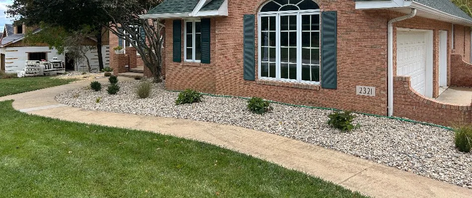 Brick house in St. Jacob, IL, with a rock landscape bed and walkway.