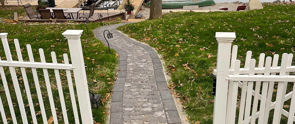 A cobblestone walkway installed for a backyard landscape in Troy, IL.
