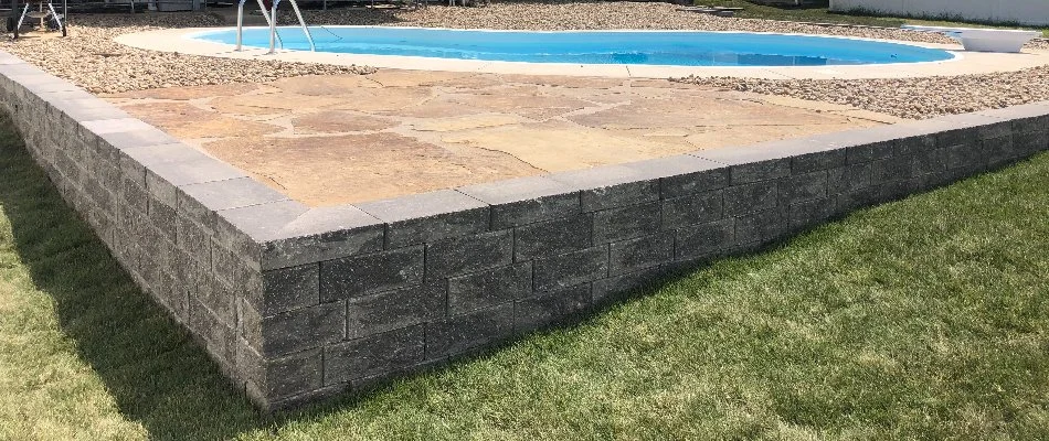 Concrete block retaining wall with a pool in Edwardsville, IL.