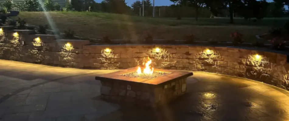 Custom fire pit and gravel mulch near a boat dock in Edwardsville, IL.