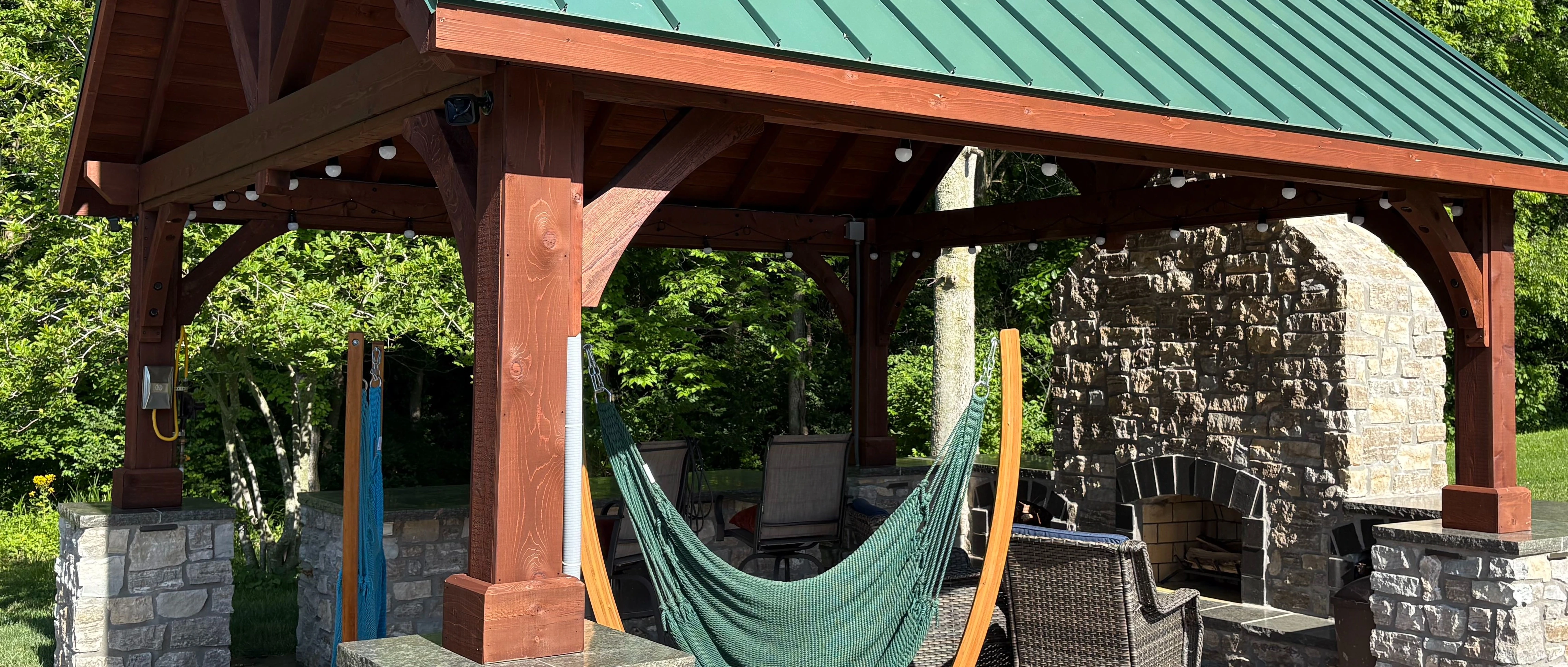 Elegant outdoor pergola seating with stone accents in Edwardsville, IL.