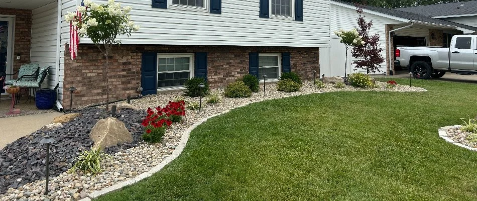 A home's landscape in Edwardsville, IL, with plants, rocks, and lighting.