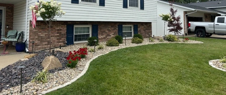 Landscape beds with rocks and plants in front of a home in Edwardsville, IL.