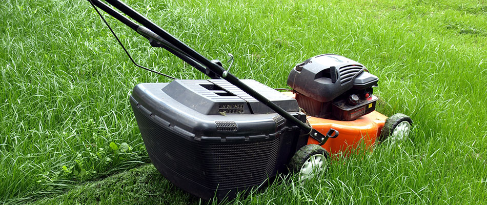 A close up on a lawn mower cutting grass in front of a home in Maryville, IL.