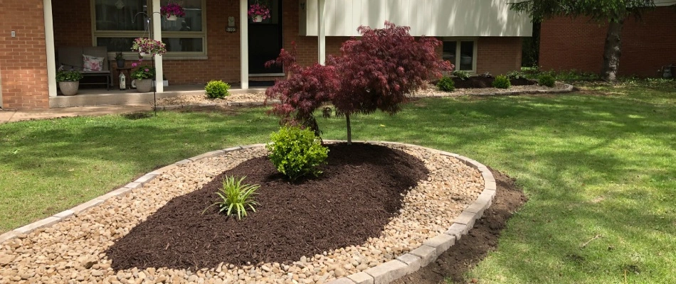 Mulch and rock landscape bed installed with plantings in Staunton, IL.