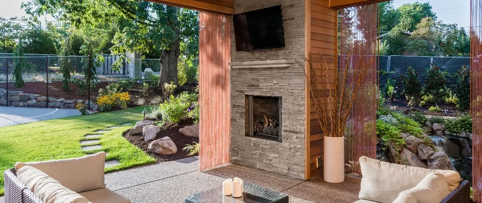 Outdoor fireplace with a TV on a property in Edwardsville, IL.