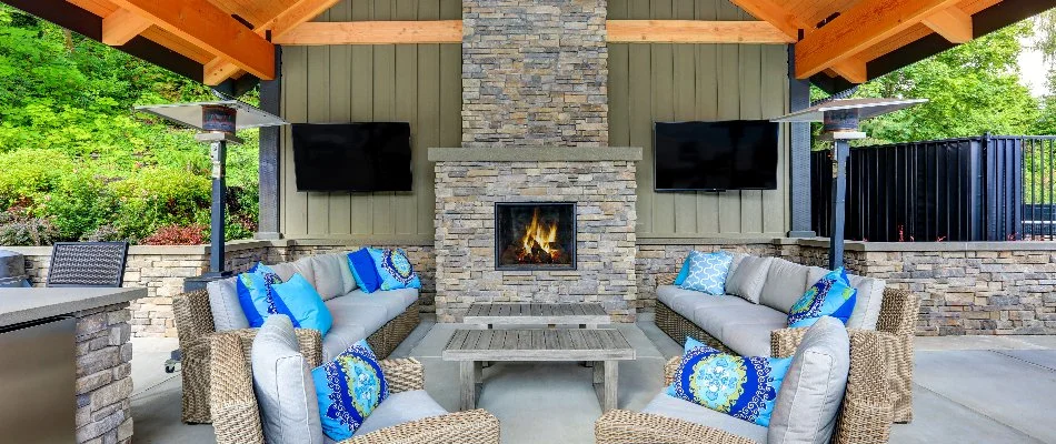 Outdoor fireplace with furniture in front of it on a property in Edwardsville, IL.