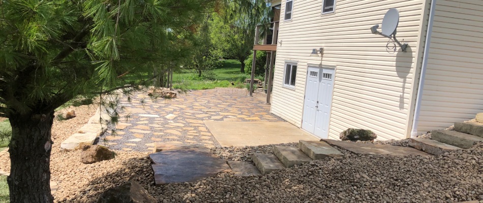 Stone patio and walkway installed over slope in Brighton, IL.