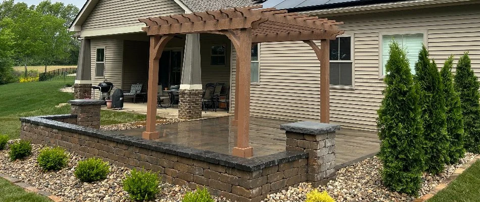 Patio in Jersey County, IL, with pergola and seating wall.