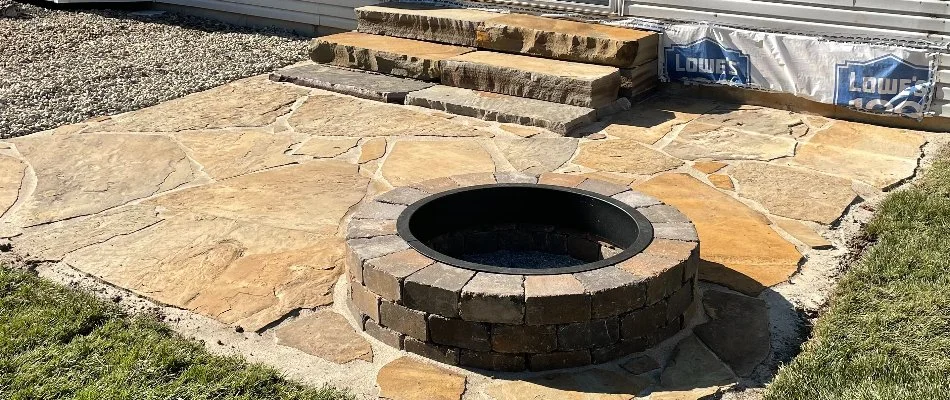 Round fire pit on a patio in Madison County, IL.