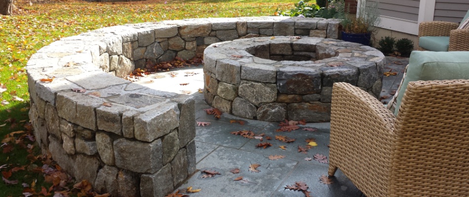 Seating wall installed built around fire pit in Hartford, IL.