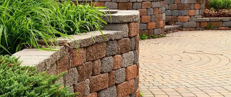 Stone retaining wall and landscape bed designs at a Edwardsville, Illinois property.