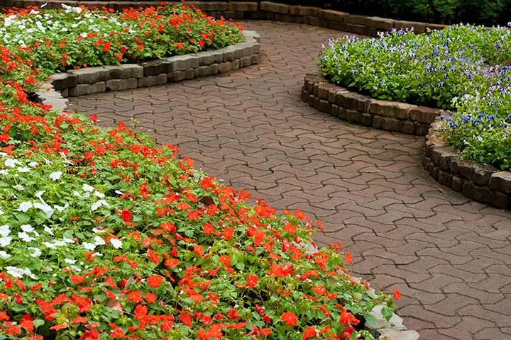 Red paver walkway and landscape beds with annual flowers near Glen Carbon, IL.